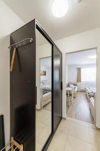 a sliding glass door leading to a room with beds at Penzion DaJa in Horní Planá
