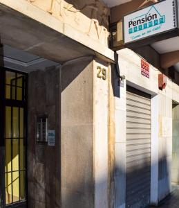 a building with a sign on the side of it at Pension Waksman in Valencia