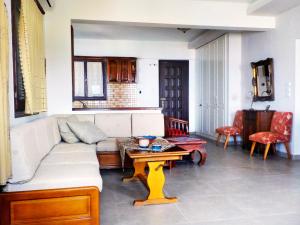 a living room with a couch and a table at Lefkothea Studios in Chorto