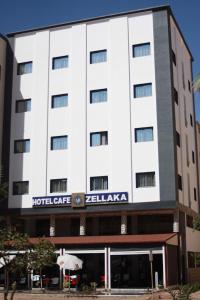 a hotel building with a hotel gate relaria at ZELLAKA hôtel & café in Khouribga