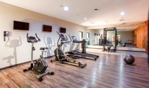 a gym with several treadmills and exercise bikes at Solia Legian Bali in Legian
