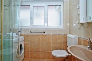 bagno con servizi igienici, lavandino e lavatrice di Apartments Emi a Dubrovnik