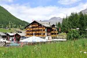 a large building in the middle of a mountain at Hotel THE LARIX ski-in ski-out in Saas-Fee