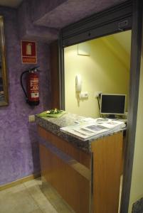 a reception desk in a room with a phone at Hostal La Cortijana in Logroño