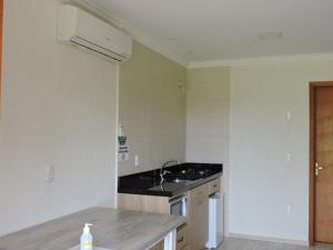 a kitchen with a sink and a counter top at Pousada Villa Romantica in Nova Petrópolis +119 photos