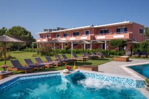 a swimming pool with chairs and a resort at The Wave in Sidari