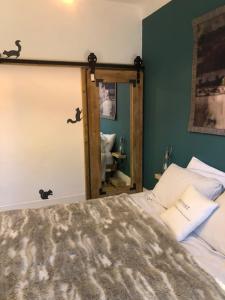 a bedroom with a bed and a mirror at Chambers Apartment @ The Old Magistrates in Betws-y-coed