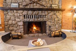 a fire place in front of a stone fireplace at LOGE Breckenridge in Breckenridge