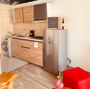 a kitchen with a stainless steel refrigerator and a stove at Apartamento zona colonial lindísimo (102) in Zipaquirá