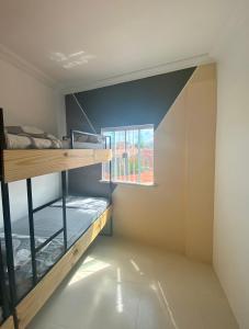 Habitación con litera y ventana en 4ª Cia Hostel e Pousada, en Fortaleza