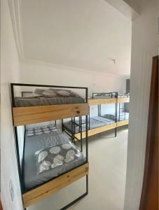 a room with three bunk beds in a room at 4ª Cia Hostel e Pousada in Fortaleza