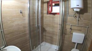 a small bathroom with a shower and a toilet at Apartman Romanija Dolina mira in Pale