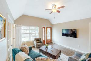 a living room with a couch and a ceiling fan at Urban Villita in San Antonio