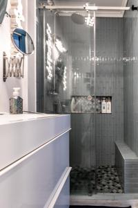 a shower with a glass door in a bathroom at Casa Vista Marina in Ponta Delgada
