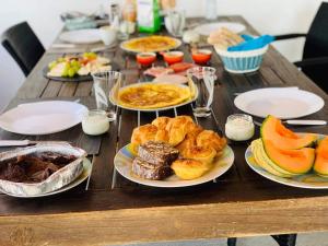 uma mesa de madeira com pratos de comida em Casa do Loureiro Branco em Santarém