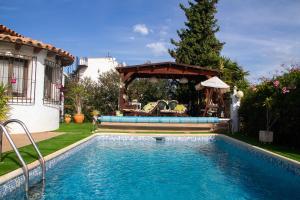 a swimming pool in a yard with a gazebo at El Rincón de la Quinta in Calpe