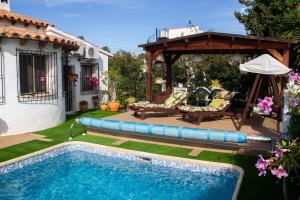 a swimming pool in a yard with a gazebo at El Rincón de la Quinta in Calpe