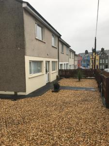 a row of houses on a gravel yard at 8 Queenora Avenue in Portstewart