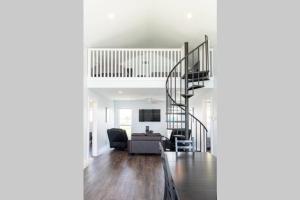 a living room with a staircase in a house at Beach Front on West Beach in Galveston