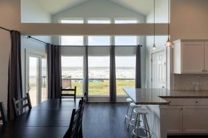 a kitchen and dining room with a table and chairs at Beach Front on West Beach in Galveston