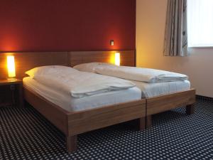 מיטה או מיטות בחדר ב-Hotel Greive