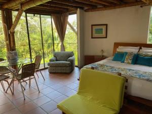 a bedroom with a bed and a table and chairs at Finca Agualinda in San Francisco