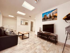 a living room with a large flat screen tv at Ferienwohnungen Mey Haus zum Rosenstock in Erfurt