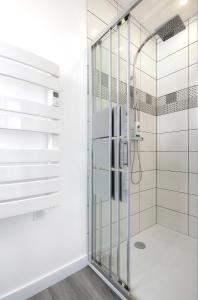 a glass shower in a bathroom with white walls at Hypercentre 10 rue Valdemaine in Angers