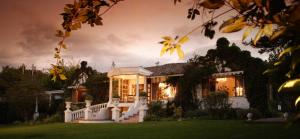 a large house with a staircase in front of it at La Mirage Garden Hotel & Spa in Cotacachi