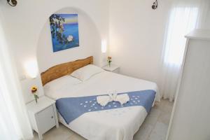 a bedroom with a bed with a blue and white blanket at Villa Liquattruvienti in Leuca +53 photos