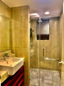 a bathroom with a sink and a shower at MrK Penthouse at Timurbay in Kuantan