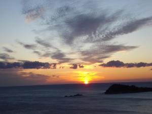 a sunset over the ocean with the sun in the sky at Fox Apartments in Cavtat