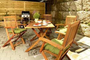 a wooden table and chairs on a patio at ChiemseeLeben in Breitbrunn am Chiemsee