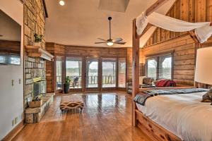 a bedroom with a bed and a fireplace at Hot Tub, Grill Hilltop Log Cabin in Hot Springs! in Hot Springs