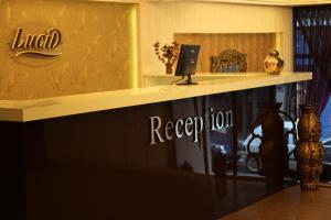 a reception desk with a laptop on top of it at Lucid Hotel in İzmir