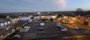 a city with cars parked in a parking lot at Apparthotel loft Martigné-Ferchaud in Martigné-Ferchaud