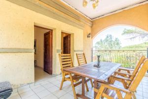 a dining room with a table and chairs on a balcony at Aloha Lodge 2 Bedroom Apartment near Menlyn Sleeps 4 in Pretoria