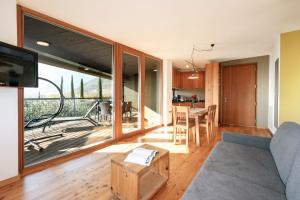 a living room with a couch and a table with a television at Biobauernhof St. Quirinus in Caldaro