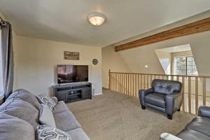 a living room with a couch and a tv and a chair at Spacious Family Home Surrounded by Mtn Views! in Flagstaff