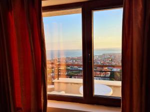 a window with a view of a city at Sea View Hills in Sveti Vlas