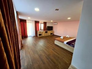 a hotel room with a bed and a television at Sea View Hills in Sveti Vlas