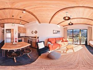 a living room with a couch and a table at Lantern 1 Bedroom Balcony Alpine Style in Thredbo