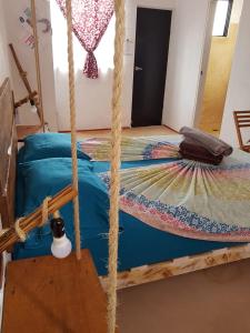 a bedroom with a bed and a canopy at EncantaLuna in Holbox Island