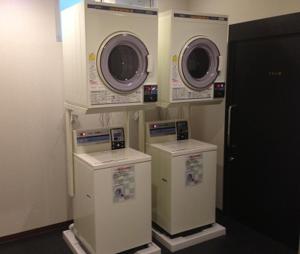a laundry room with two washers and three machines at HOTEL LiVEMAX Himeji Ekimae in Himeji +7 photos