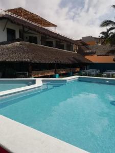 a large swimming pool in front of a building at El Encanto Casa Boutique in Manzanillo +31 photos