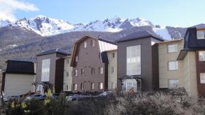 a row of buildings with mountains in the background at Latitud Catedral Apartamento in San Carlos de Bariloche