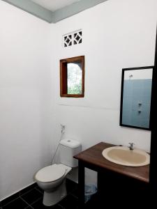 a bathroom with a toilet and a sink at Merdeka House in Maluk +38 photos