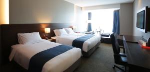 Postel nebo postele na pokoji v ubytování ASTI Hotel Busan Station