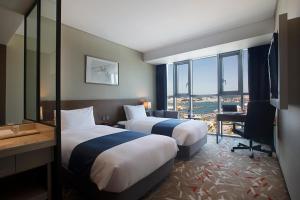 Postel nebo postele na pokoji v ubytování ASTI Hotel Busan Station