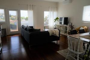 a living room with a couch and a table at Retreat in Albany